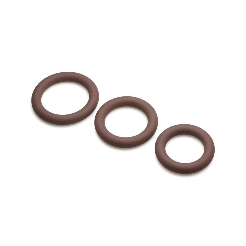 Three brown skin tone Jock Discreet silicone cock rings shown graduated in small, medium, and large sizes.