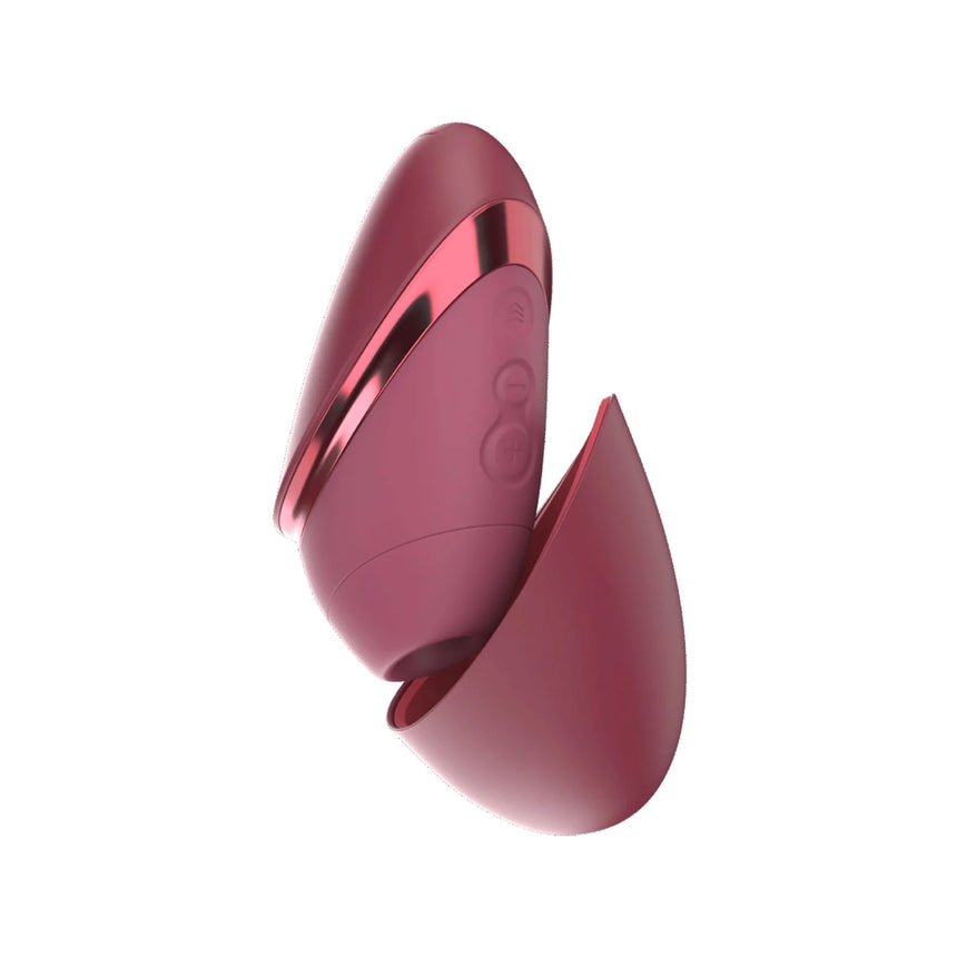 Red Womanizer Next Liberty stimulator shown with its matching red protective magnetic cap detached.