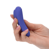 Hand holding the purple CalExotics Connect Panty Teaser vibrator to display its slim, discreet size and shape.