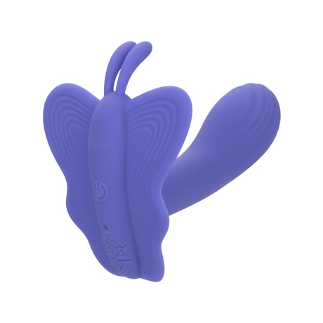 A purple silicone butterfly-shaped adult novelty massager with a curved suction-style stimulator arm, shown on a solid white background.