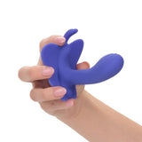 Hand holding the purple CalExotics Connect Venus Butterfly stimulator to display scale and ergonomic curve.
