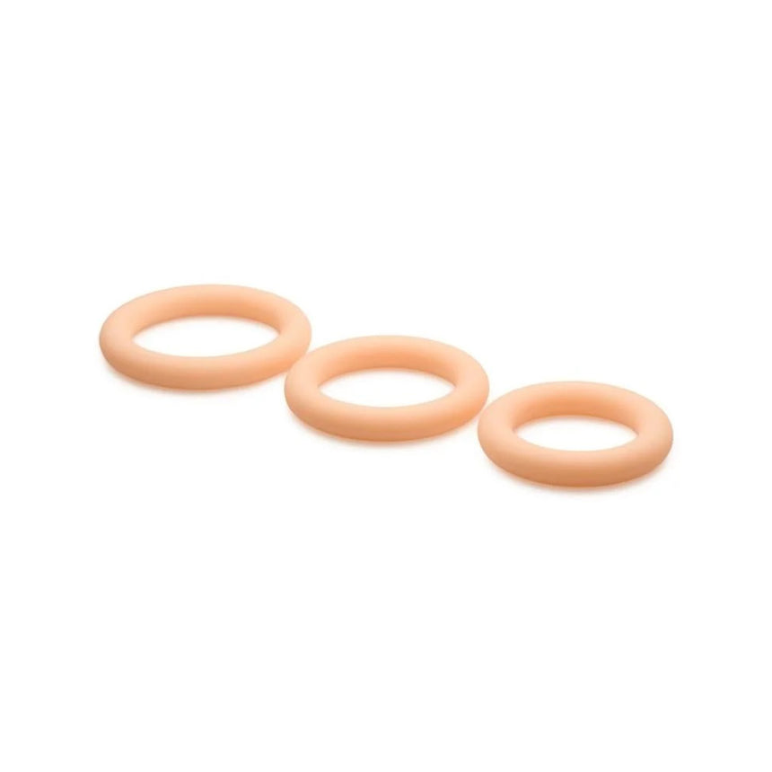 Three vanilla skin tone Jock Discreet silicone cock rings shown graduated in small, medium, and large sizes.