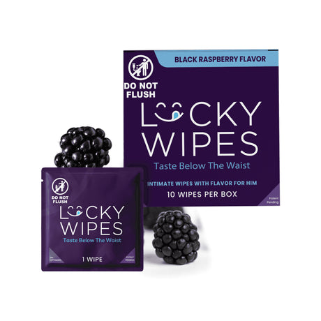 Lucky Wipes black raspberry flavored intimate wipes shown with a large purple box, a single-wipe pouch, and two blackberries on a white background.