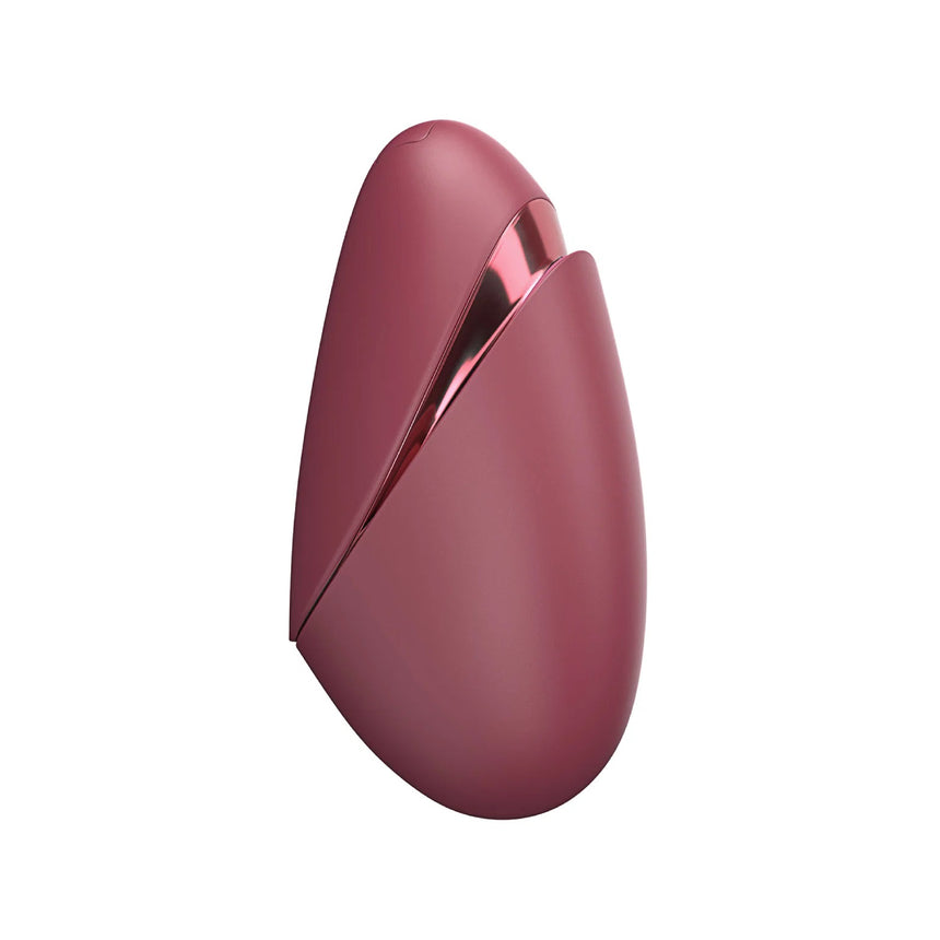 Smooth rear view of the red Womanizer Next Liberty showcasing the compact, ergonomic silicone grip.