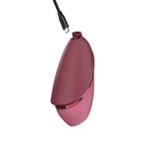 Side angle profile of the red Womanizer Next Liberty clitoral stimulator highlighting the angled stimulation head.